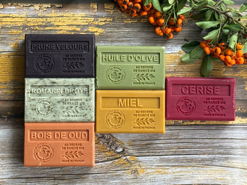 Set of colourful Marseille soap bars wa wooden surface.