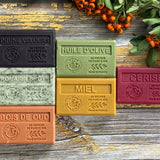 Set of colourful Marseille soap bars wa wooden surface.
