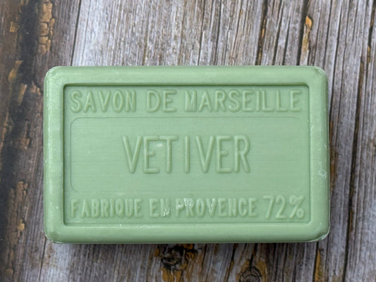 Green soap bar labeled 'Savon de Marseille Vetiver' on a wooden surface