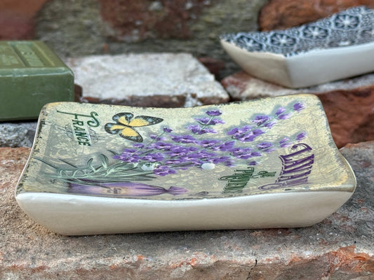 Decorative soap with lavender and butterfly design on a stone surface