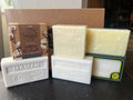 Collection of soaps with visible branding on a dark surface
